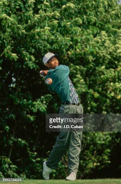 Tiger Woods from the United States follows his drive onto the fairway after teeing off during the United States Amateur Championship golf tournament...