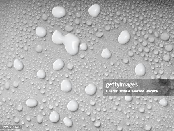 milk drops splash slide on a surface with small water droplets. - chocolate cake texture stock pictures, royalty-free photos & images