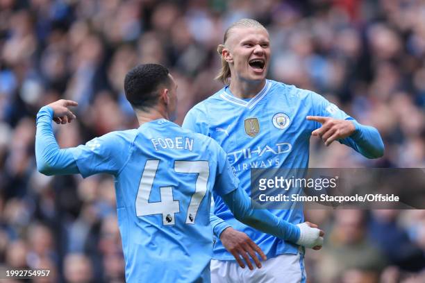 Erling Haaland of Manchester City celebrates with Phil Foden of Manchester City after scoring their 1st goal during the Premier League match between...