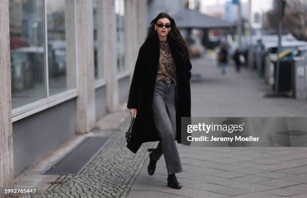 Celine Bethmann seen wearing Dior gold earrings, Le Specs black oval sunglasses, Jaded London brown leopard pattern wool knit cardigan jacket, Levi's...