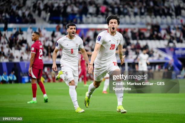 Sardar Azmoun of Iran celebrates his team's first goal with Mehdi Taremi of Iran during the AFC Asian Cup semi final match between Iran and Qatar at...