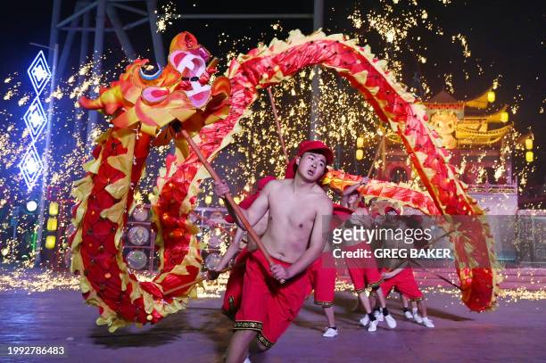 Dragon dancers perform at a park on the first day of the Lunar New Year of the Dragon in Beijing on February 10, 2024.