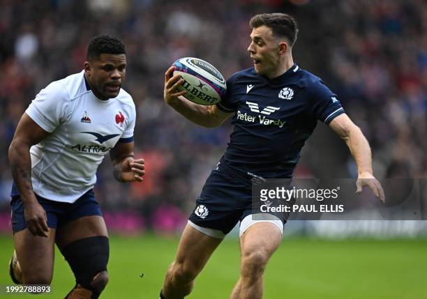 Scotland's scrum-half Ben White gathers the ball chased by France's centre Jonathan Danty in the build-up to the first try during the Six Nations...