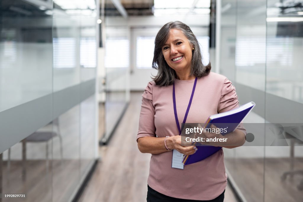 Portrait of a happy teacher smiling at the university