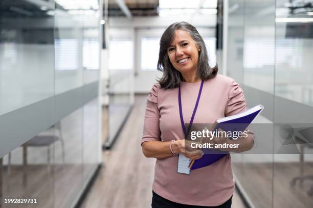 portrait of a happy teacher smiling at the university - identity card stock pictures, royalty-free photos & images