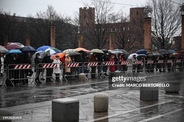 People stand outside the Duomo cathedral in Turin, with the Palatine Gate in background, during the funeral ceremony of late Prince Vittorio Emanuele...