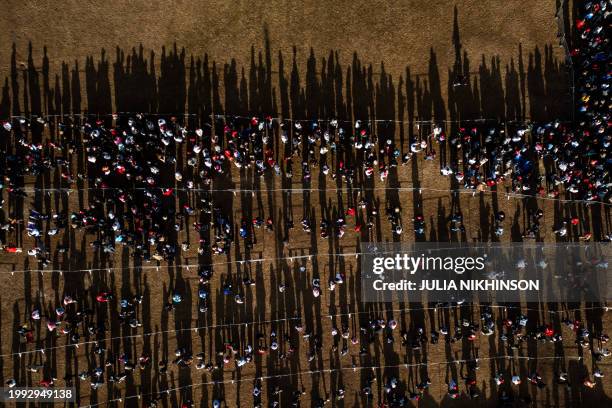 In an aerial view, supporters of former US President and 2024 presidential hopeful Donald Trump wait to enter a "Get Out the Vote" rally in Conway,...