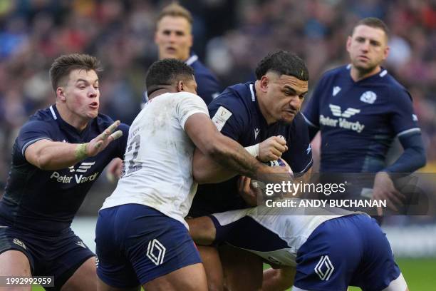 Scotland's centre Sione Tuipulotu is tackled during the Six Nations international rugby union match between Scotland and France at Murrayfield...