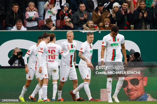 Augsburg's players celebrate the 1-0 goal by German forward Phillip Tietz during the German first division Bundesliga football match between FC...