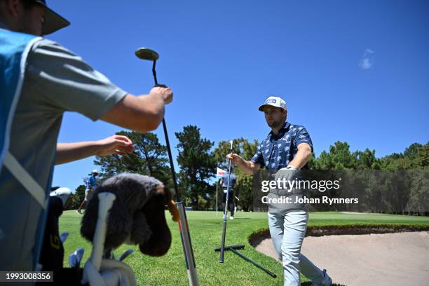 Rasmus Neergaard-Petersen from Denmark takes his putter from his caddie during day three of the Bain's Whisky Cape Town Open at Royal Cape Golf Club...