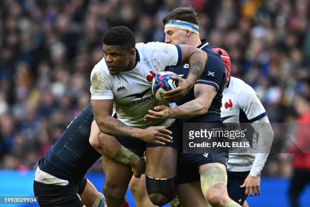 France's centre Jonathan Danty is tackled by Scotland's number 8 Jack Dempsey and Scotland's flanker Rory Darge during the Six Nations international...