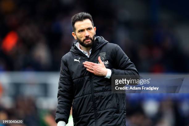 Carlos Corberan Head Coach of West Bromwich Albion pats his chest and the club badge as he applauds the travelling West Bromwich Albion fans after...