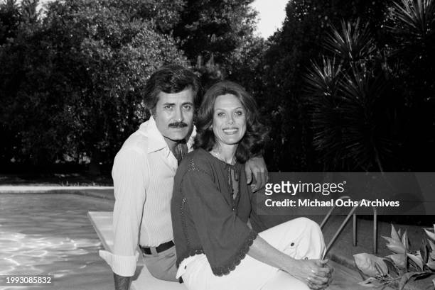 American actress Nancy Dow and her husband, Greek-born American actor John Aniston pose beside the swimming pool at home in the Sherman Oaks...