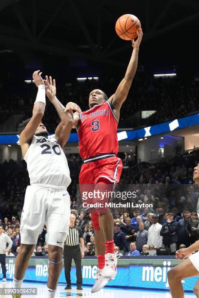 Jordan Dingle of the St. John's Red Storm takes a shot over Dayvion McKnight of the Xavier Musketeers during a college basketball game at the Cintas...