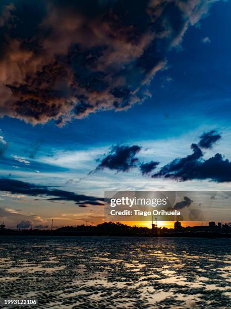 sunset at low tide of the amazon river - marrom stock-fotos und bilder