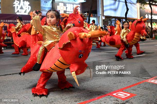 Children dressed in a dragon costume take part in the International Lunar New Year Parade on the first day of the Lunar New Year of the Dragon in...