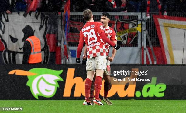 Jonathan Burkardt of 1.FSV Mainz 05 celebrates scoring his team's first goal with teammate Nadiem Amiri during the Bundesliga match between 1. FSV...