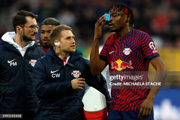 Leipzig's French defender Mohamed Simakan reacts injured during the German first division Bundesliga football match between FC Augsburg and RB...