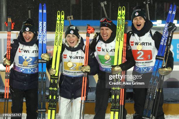 Gold medallists Julia Simon, Justine Braisaz-Bouchet, Quentin Fillon Maillet and Eric Perrot of Team France pose for a photo following the medal...