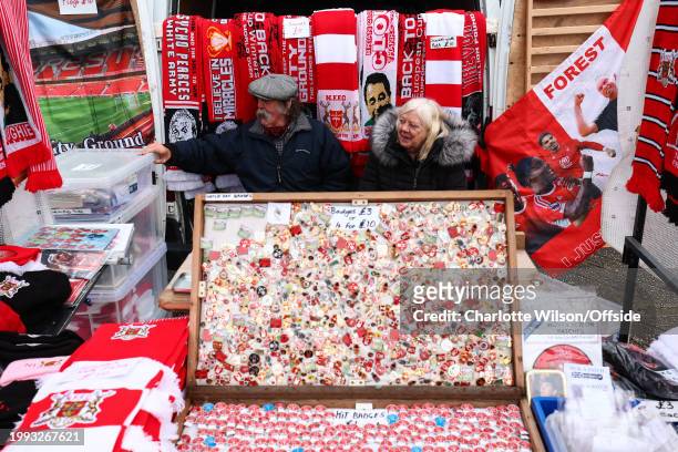 Merchandise sellers sit in the back of their van behind their wares for sale ahead of the Premier League match between Nottingham Forest and...