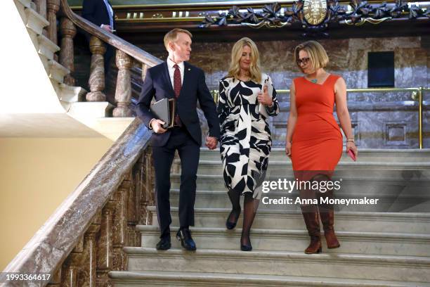 Sen. James Lankford , Lankford's wife Cindy Lankford, and Sen. Kyrsten Sinema walk down a stairwell near the Senate Chambers at the U.S Capitol...