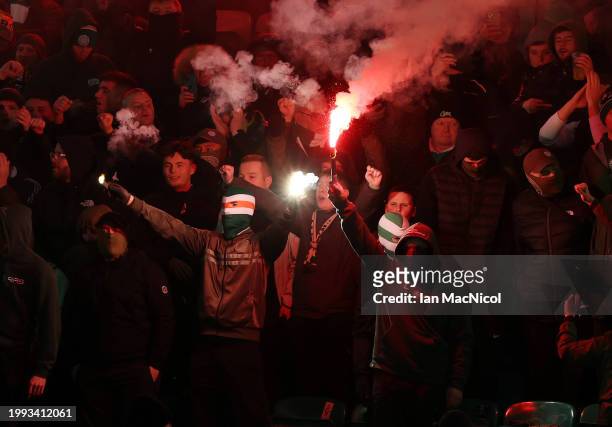 Celtic fans are seen with flares during the Cinch Scottish Premiership match between Hibernian FC and Celtic FC at Easter Road on February 07, 2024...