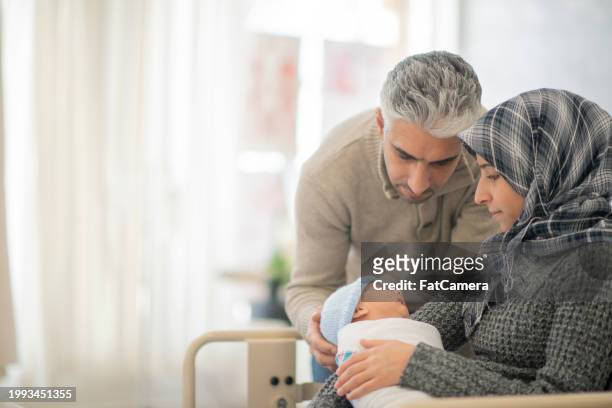 welcoming a new addition - arab couple stock pictures, royalty-free photos & images