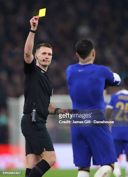 Referee Thomas Bramall shows a yellow card to Enzo Fernandez of Chelsea after he removed his shirt to celebrate scoring their third goal during the...