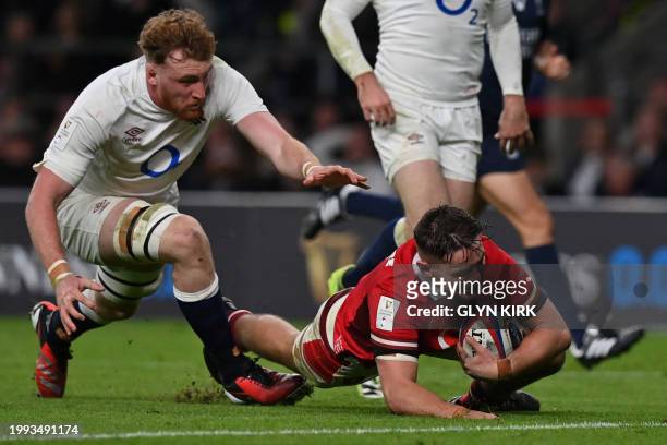 Wales' flanker Alex Mann dives to scores the team's first try during the Six Nations international rugby union match between England and Wales at...