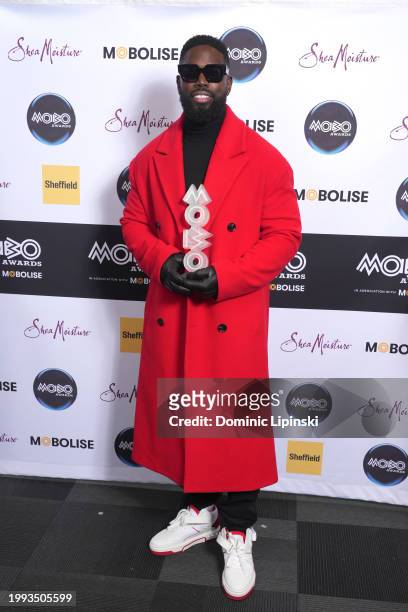 Ghetts poses with the Mobo Pioneer award in the winners room during the MOBO Awards 2024 at Utilita Arena Sheffield on February 07, 2024 in...