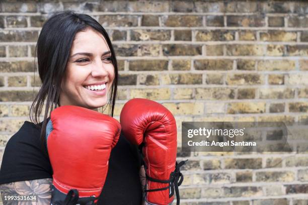 joyful female boxer smiling with red gloves - punching stock pictures, royalty-free photos & images