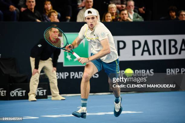 France's Ugo Humbert rushes for the ball during his men's semi-final singles tennis match against Poland's Hubert Hurkacz at the ATP Open 13 in...