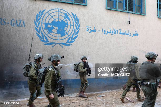 This picture taken during a media tour organised by the Israeli army on February 8 shows Israeli soldiers inside an evacuated compound of the United...