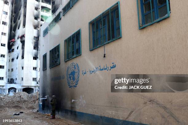 This picture taken during a media tour organised by the Israeli army on February 8 shows an Israeli soldier standing in front of a United Nations...