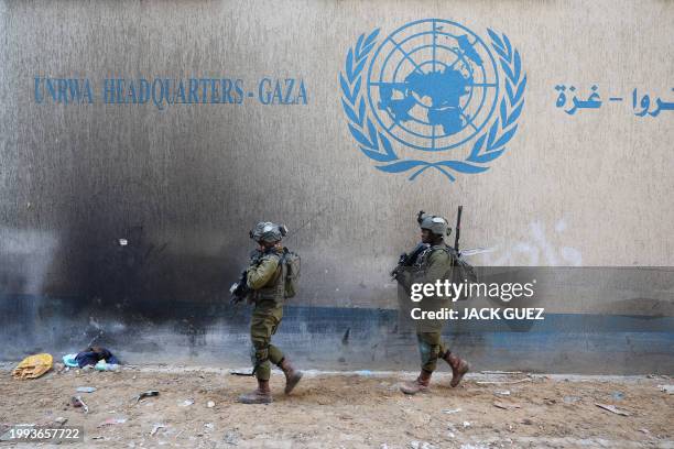 This picture taken during a media tour organised by the Israeli army on February 8 shows Israeli soldiers inside an evacuated compound of the United...