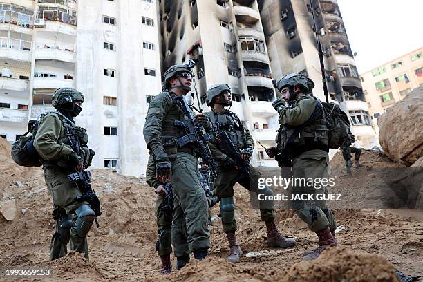 This picture taken during a media tour organised by the Israeli army on February 8 shows Israeli soldiers in an evacuated compound of the United...