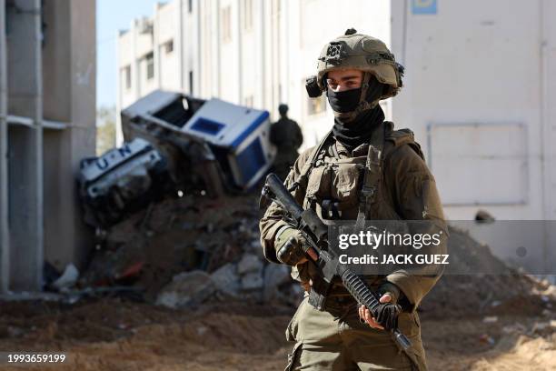 This picture taken during a media tour organised by the Israeli army on February 8 shows Israeli soldiers inside an evacuated compound of the United...