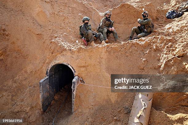 This picture taken during a media tour organised by the Israeli military on February 8 shows Israeli soldiers at the entrance of a tunnel outside the...