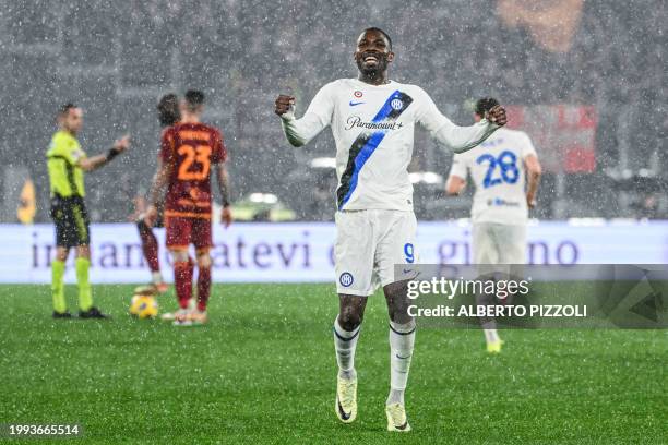 Inter Milan's French forward Marcus Thuram celebrates after AS Roma scored an own goal during the Italian Serie A football match between AS Roma and...