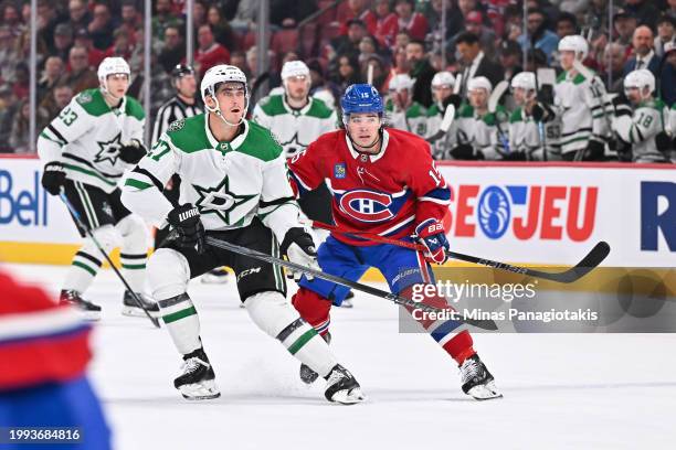 Mason Marchment of the Dallas Stars and Alex Newhook of the Montreal Canadiens skate against each other during the first period at the Bell Centre on...