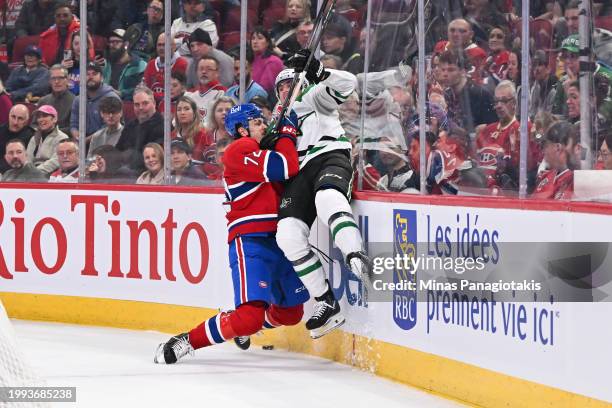 Arber Xhekaj of the Montreal Canadiens checks Mason Marchment of the Dallas Stars into the boards during the first period at the Bell Centre on...