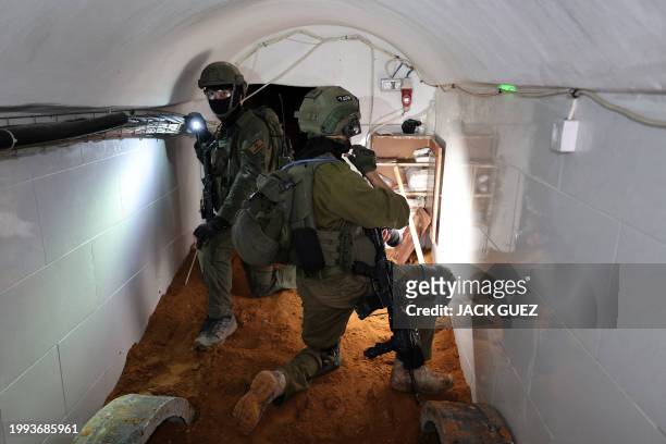 This picture taken during a media tour organised by the Israeli military on February 8 shows Israeli soldiers inside a tunnel that the army claimed...