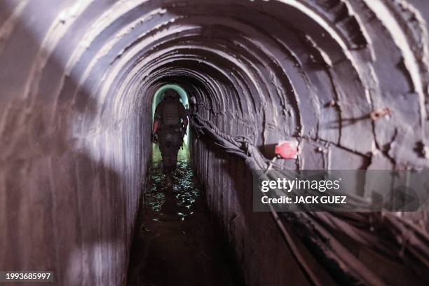 This picture taken during a media tour organised by the Israeli military on February 8 shows an Israeli soldier inside a tunnel that the army claimed...