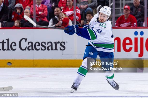 Quinn Hughes of the Vancouver Canucks shoots the puck against the Detroit Red Wings during the second period at Little Caesars Arena on February 10,...