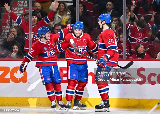 Nick Suzuki of the Montreal Canadiens celebrates his goal with teammates Cole Caufield and Juraj Slafkovsky during the second period against the...