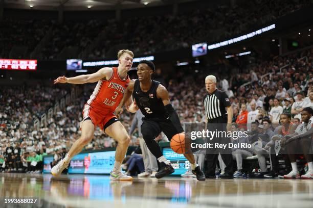 Tyson Walker of the Michigan State Spartans drives to the basket against Marcus Domask of the Illinois Fighting Illini during the first half at...