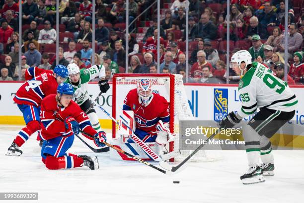 Matt Duchene of the Dallas Stars skates with the puck under pressure from Kaiden Guhle of the Montreal Canadiens during the third period of the NHL...