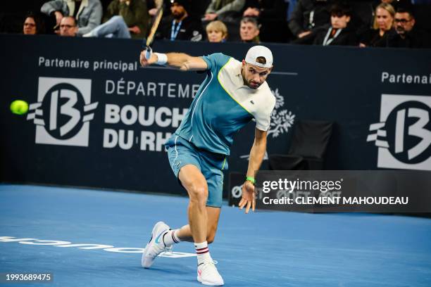 Bulgaria's Grigor Dimitrov hits a return to Russia's Karen Khachanov during their men's semi-final singles tennis match at the ATP Open 13 in...