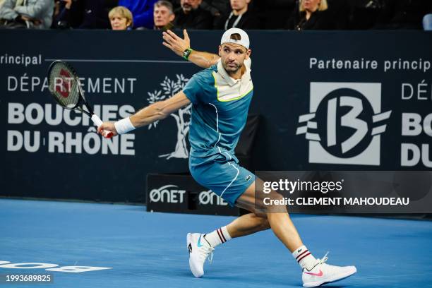 Bulgaria's Grigor Dimitrov hits a return to Russia's Karen Khachanov during their men's semi-final singles tennis match at the ATP Open 13 in...