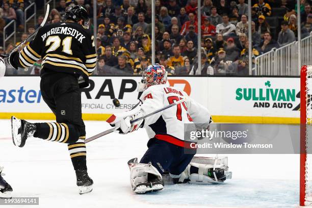 Charlie Lindgren of the Washington Capitals makes a save as James van Riemsdyk of the Boston Bruins screens him in front during the third period at...